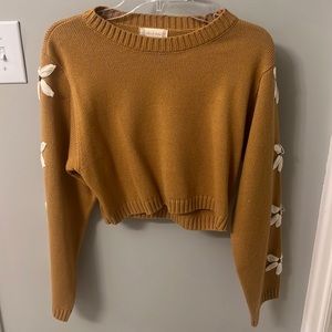Cropped muted yellow/gold sweater which flower sleeves from Altar’d State